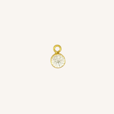Round diamond charm in gold.
