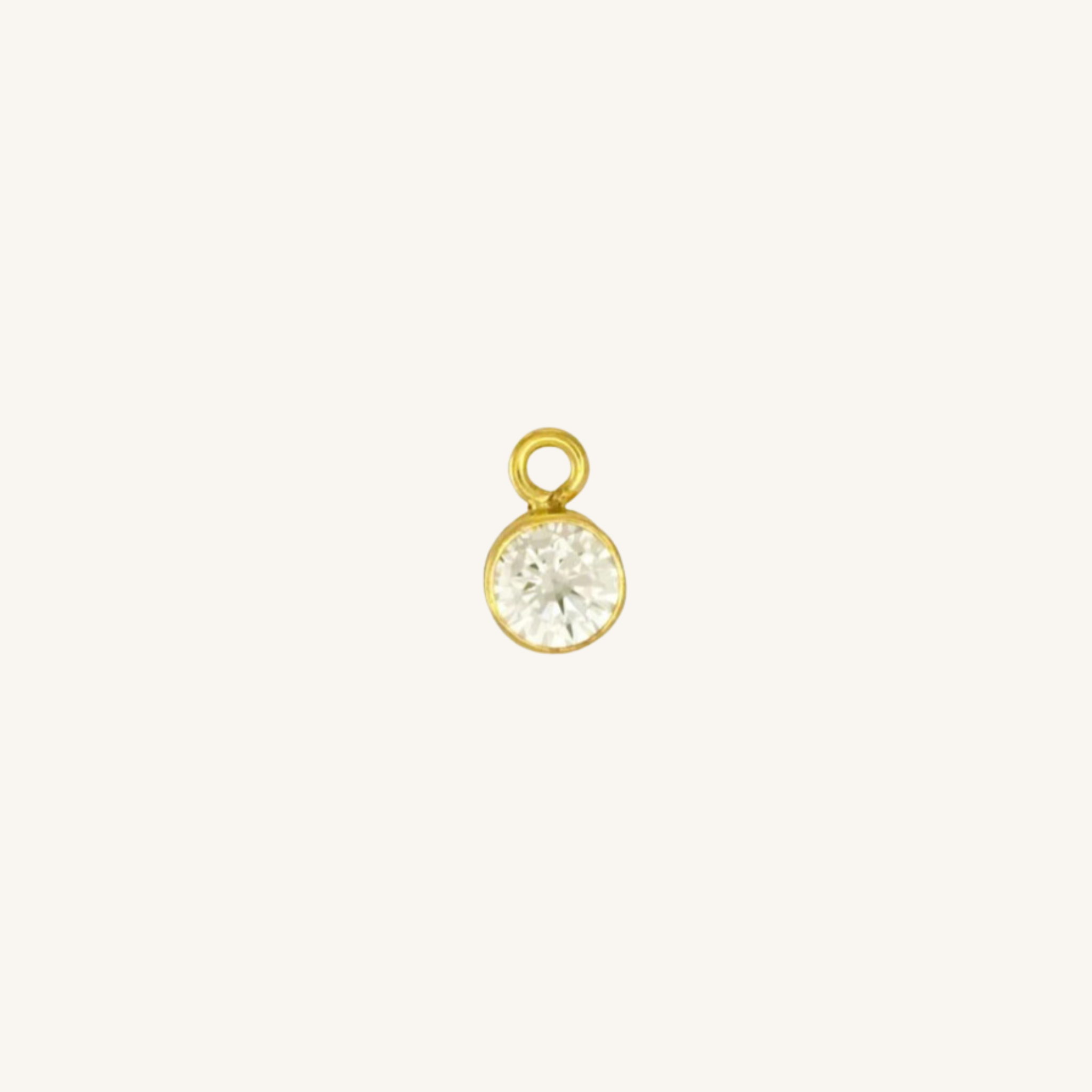 Round diamond charm in gold.