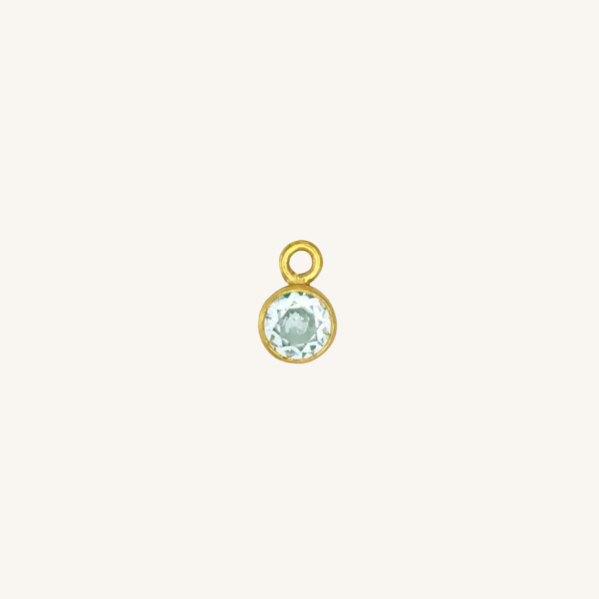 Round turquoise charm in gold on white background.