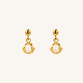 A pair of gold dangle earrings with scallop-shaped gold settings holding white pearl-like drops, shown on a plain off-white background.