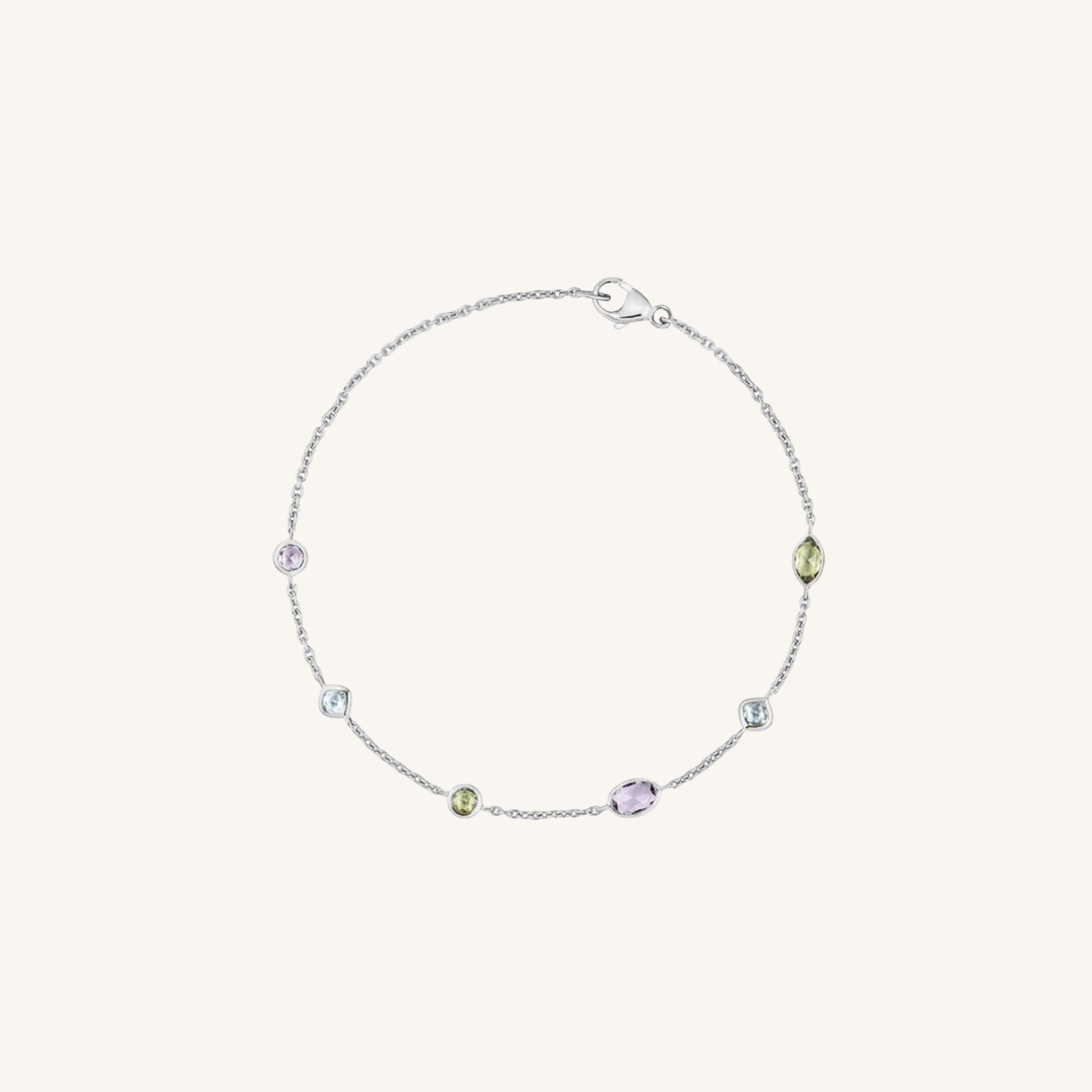 A delicate silver chain bracelet with five small, colorful gemstone accents in purple, green, and clear, displayed on a light cream background.