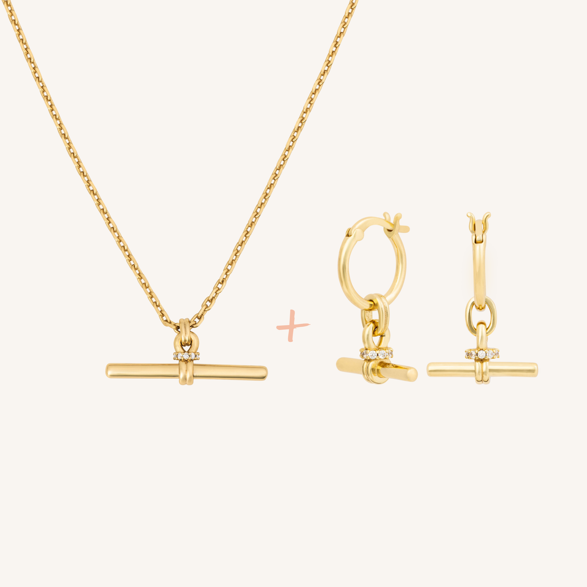 Gold jewelry set featuring a necklace with a horizontal bar pendant and matching hoop-and-bar earrings, shown on a clean off-white background with a small pink plus sign between the pieces.