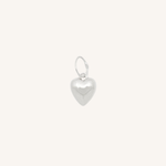 Silver heart charm on white background.
