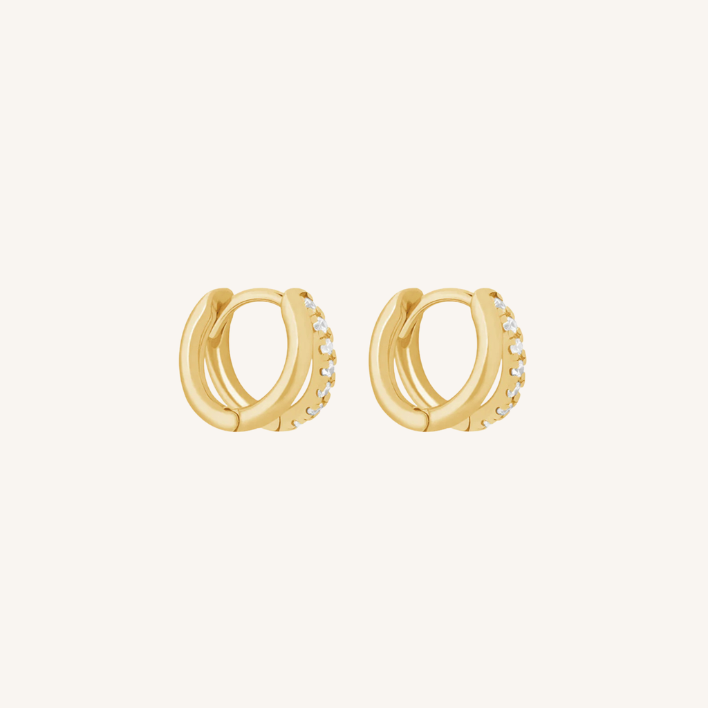 Gold hoop earrings with embedded stones on a white background