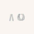 Pair of silver hoop earrings with small stones on a white background