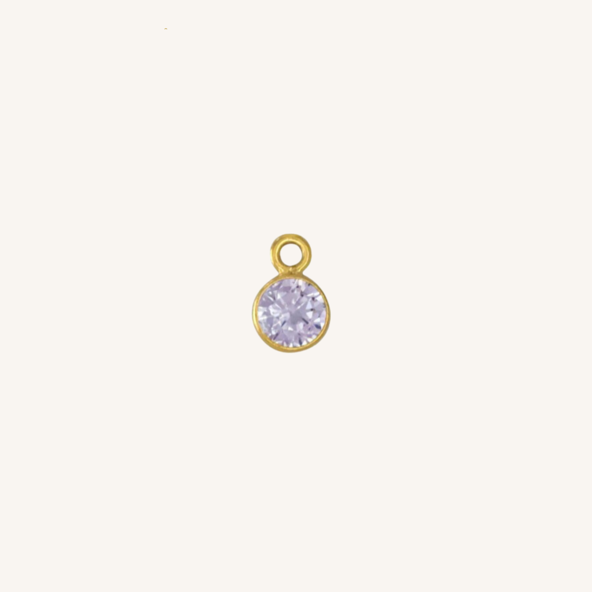 Round alexandrite charm in gold. 