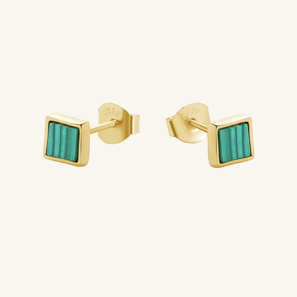 A pair of gold square stud earrings with a green striped inlay, shown on a light cream background.