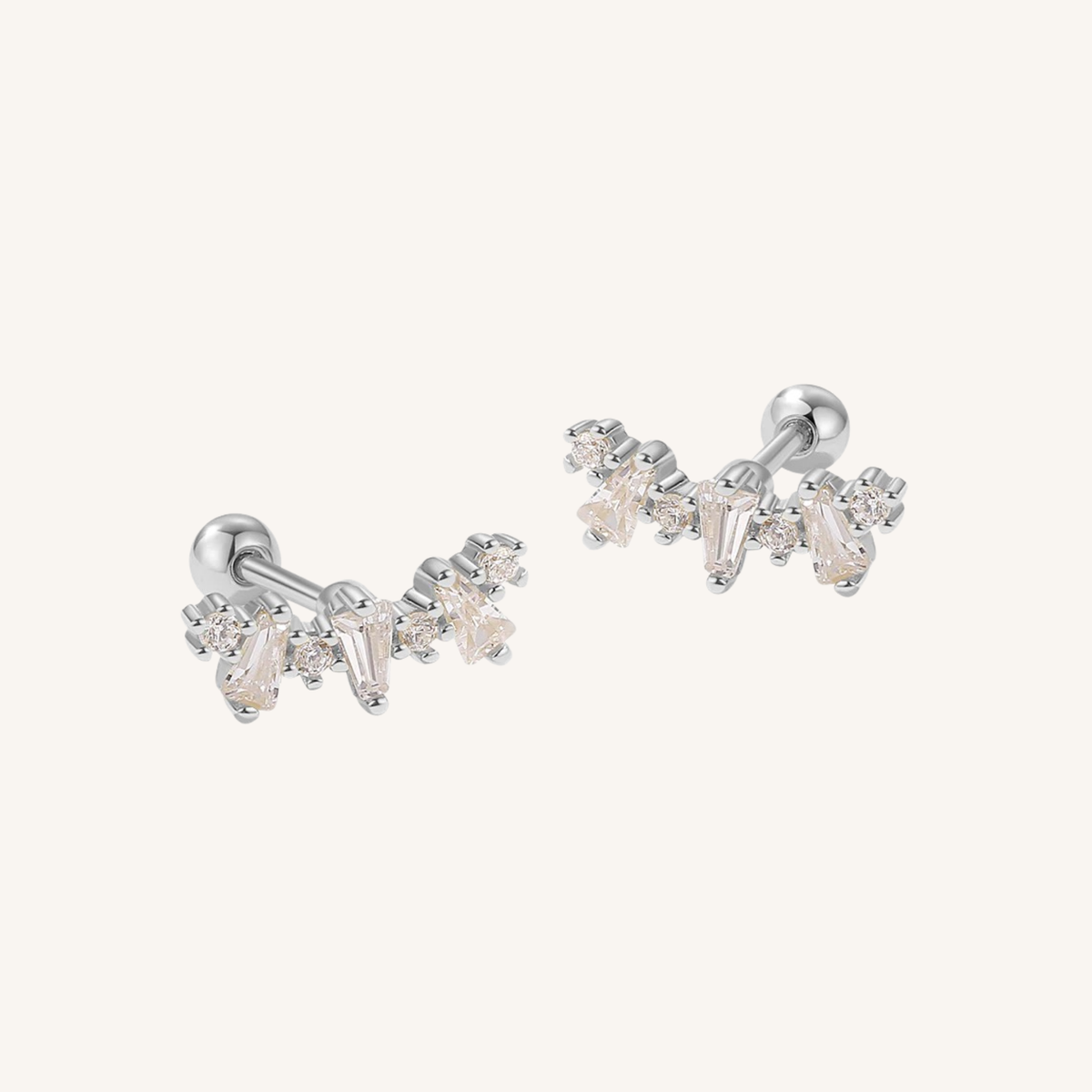 A pair of silver-toned stud earrings with clear Cubic Zirconia crystals, displayed on a clean off-white background.