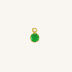 Round emerald green charm in gold on white background.