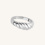 Silver ring with a twisted design on a white background