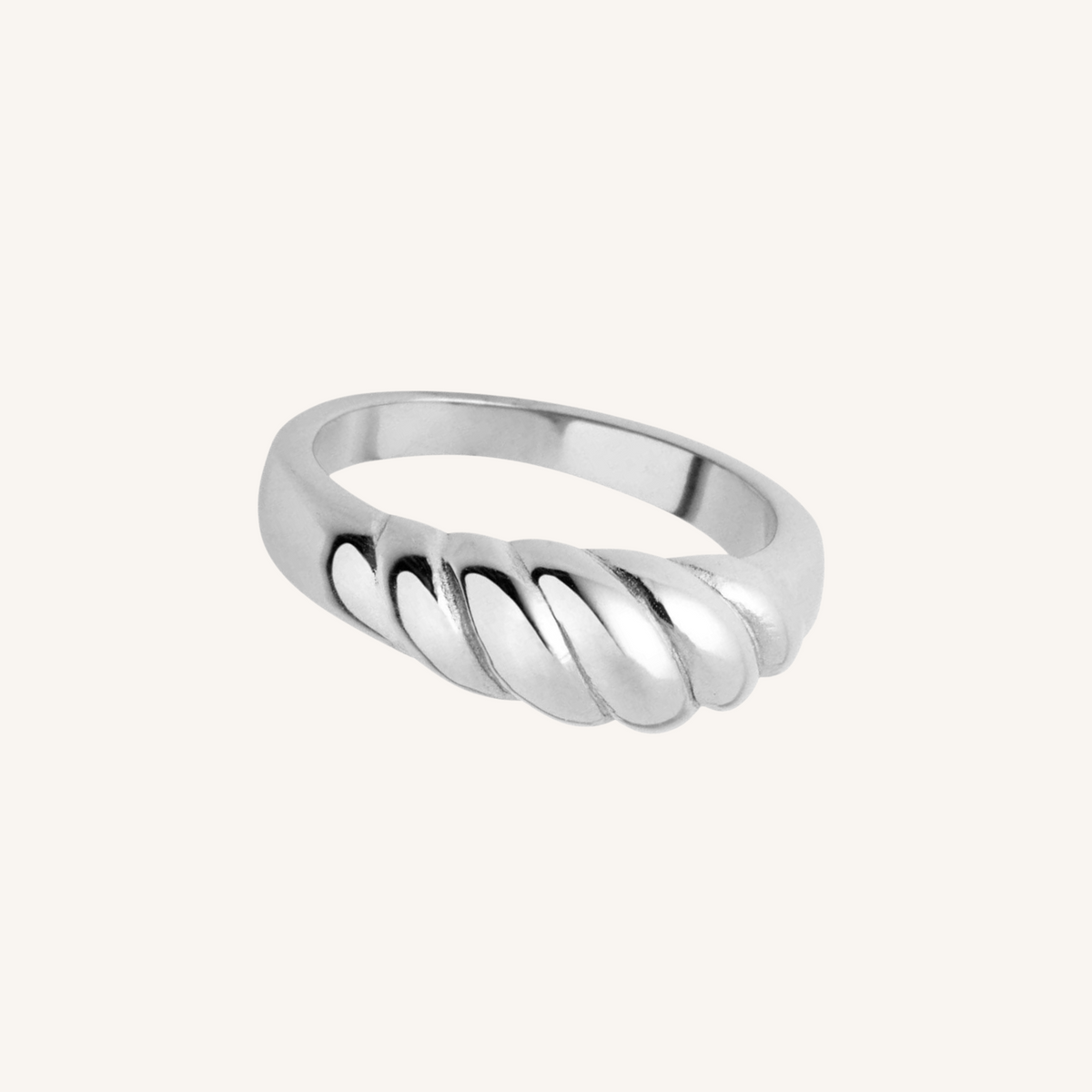 Silver ring with a twisted design on a white background