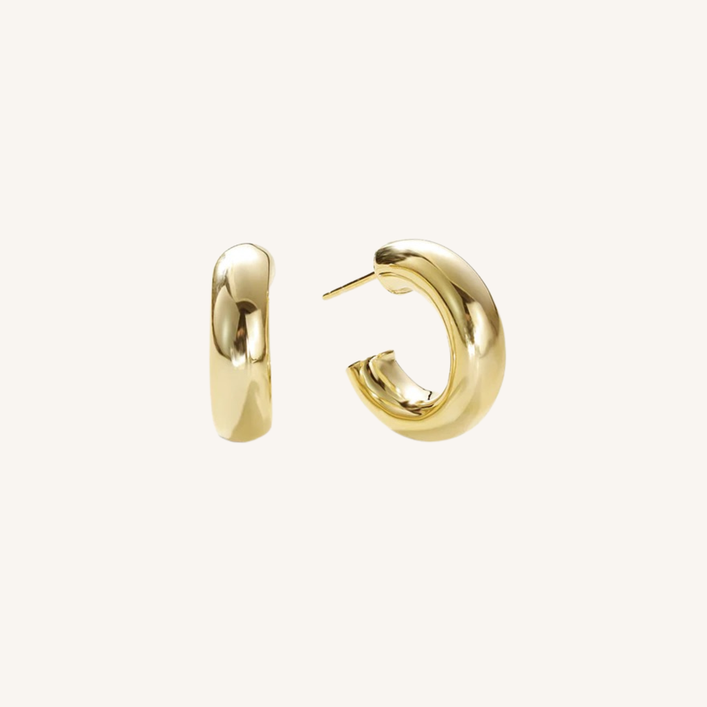 A pair of polished gold huggie hoop earrings, shown from two angles (side and back) on a clean, off-white background.