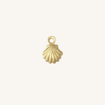 A small gold shell-shaped charm with a loop at the top, centered on a plain off-white background.