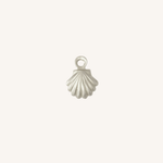 A small silver shell-shaped jewelry charm with a loop at the top, centered on a plain off-white background.