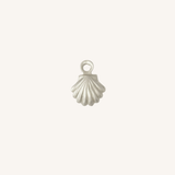 A small silver shell-shaped jewelry charm with a loop at the top, centered on a plain off-white background.
