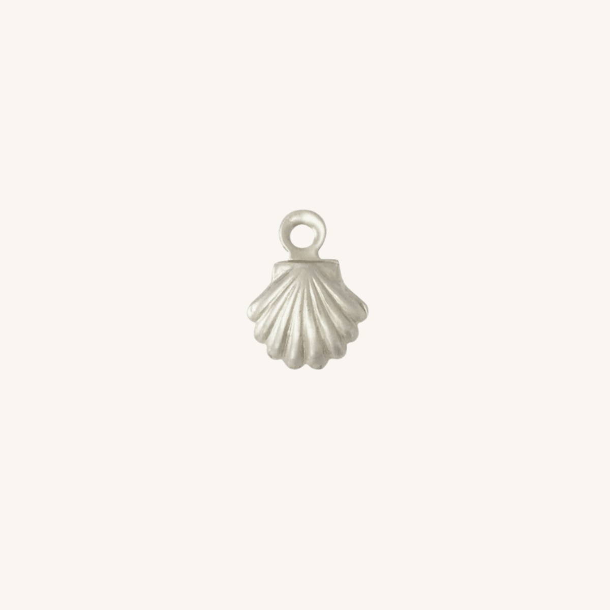 A small silver shell-shaped jewelry charm with a loop at the top, centered on a plain off-white background.