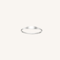 A minimalist, thin silver band ring with a polished finish, centered on a solid off-white background.