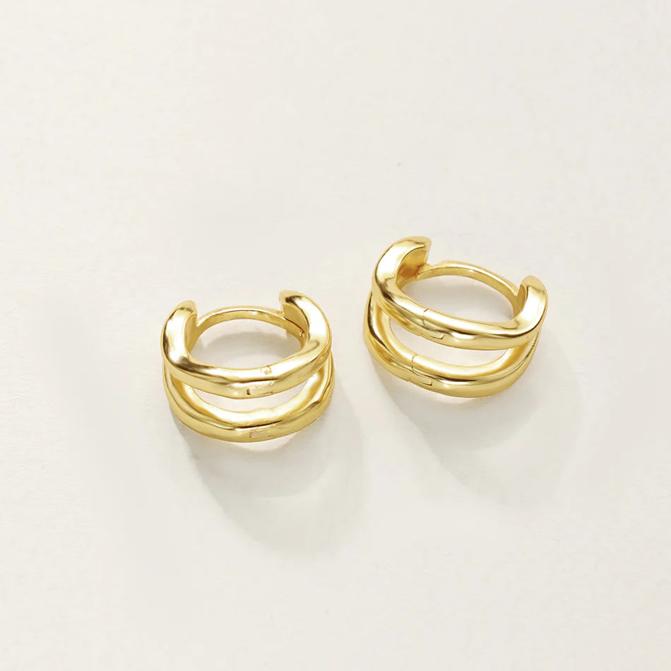 Gold hoop earrings on a white background