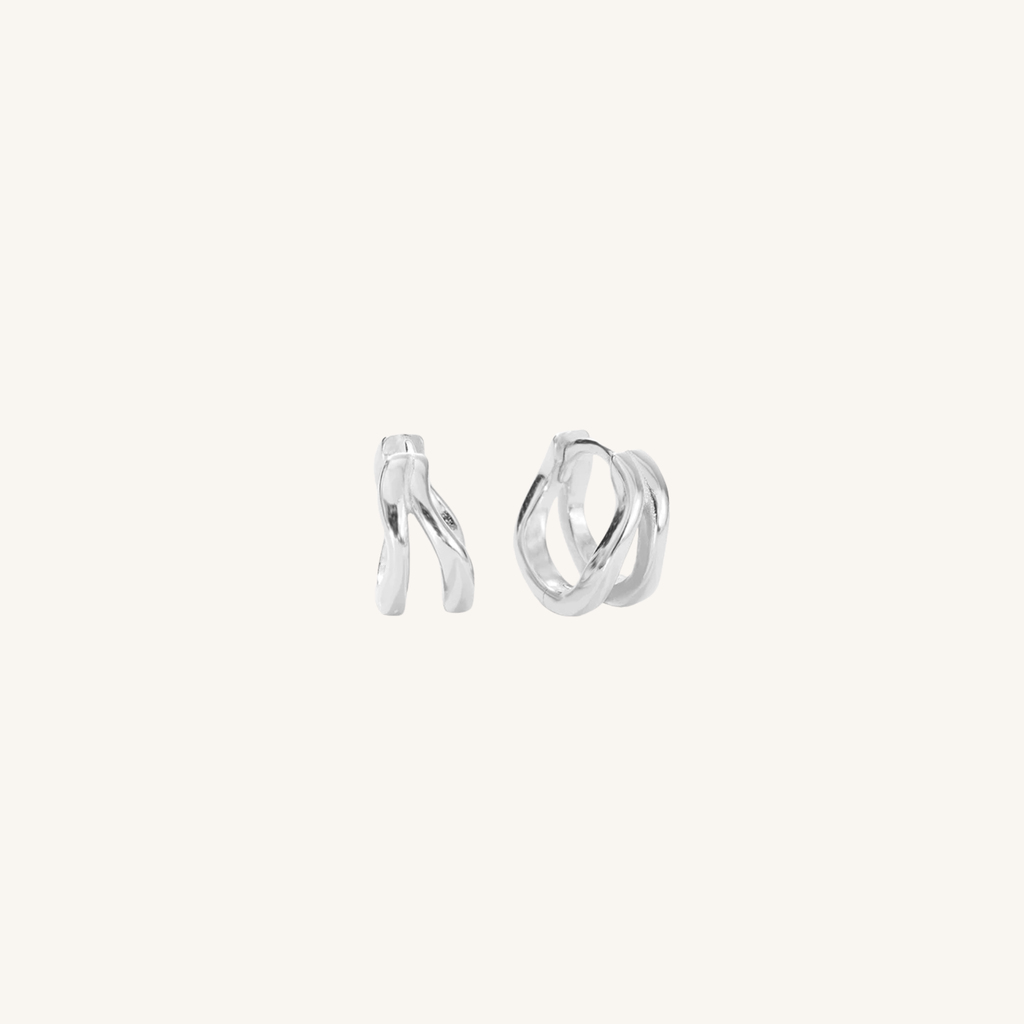 Pair of silver hoop earrings on a white background