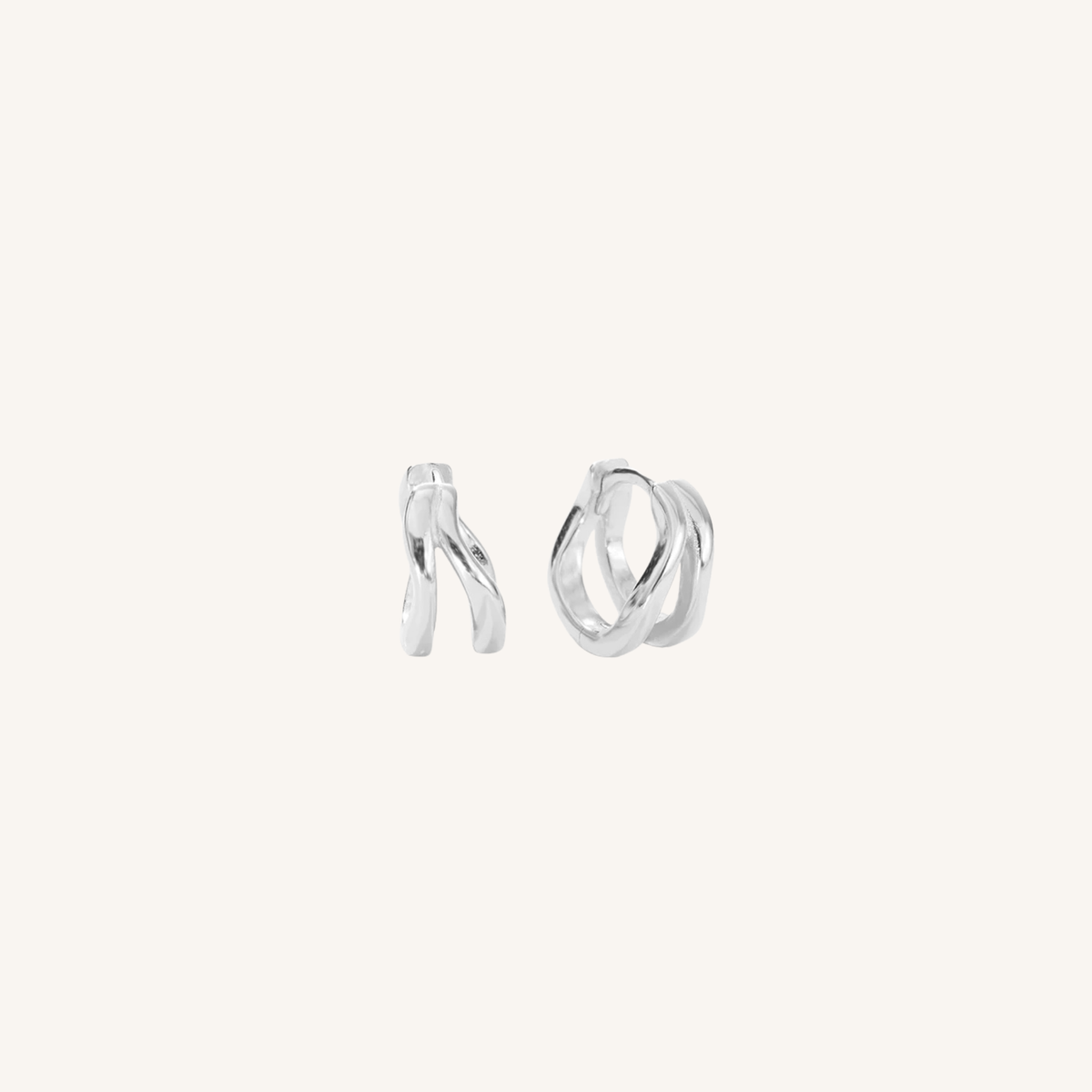 Pair of silver hoop earrings on a white background