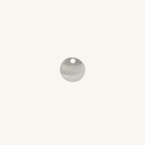A small round silver disc charm with a hole at the top, centered on a plain off-white background.