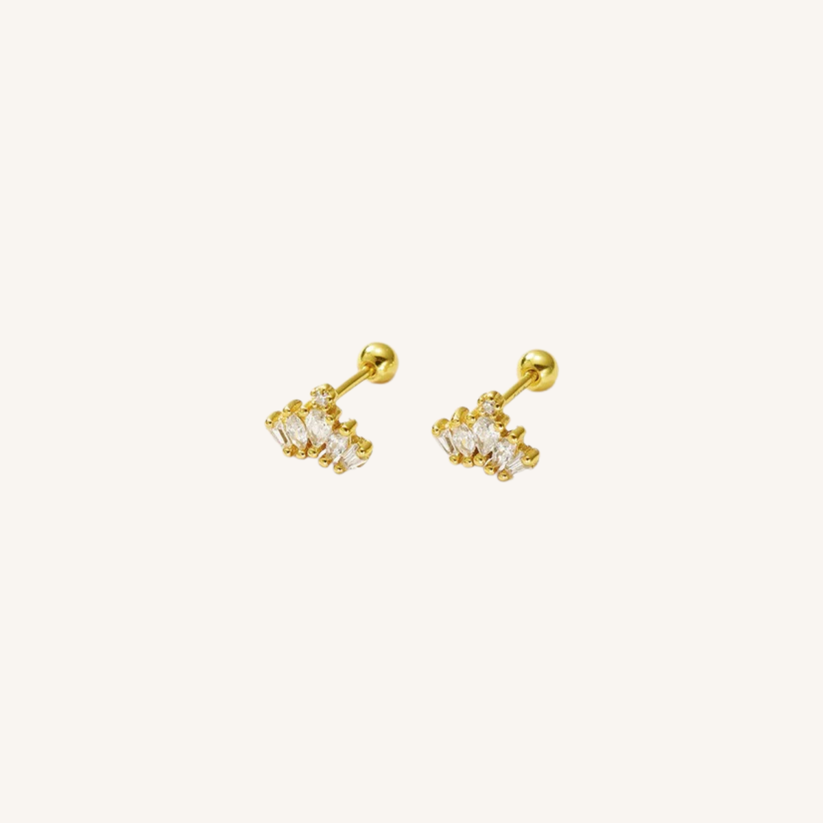 A pair of gold-toned stud earrings with clear gemstones, displayed on a clean off-white background.