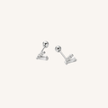 A pair of silver-toned stud earrings with a ball post and a small cluster of baguette-cut clear stones, shown on a plain off-white background.