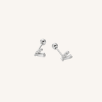 A pair of silver-toned stud earrings with a ball post and a small cluster of baguette-cut clear stones, shown on a plain off-white background.
