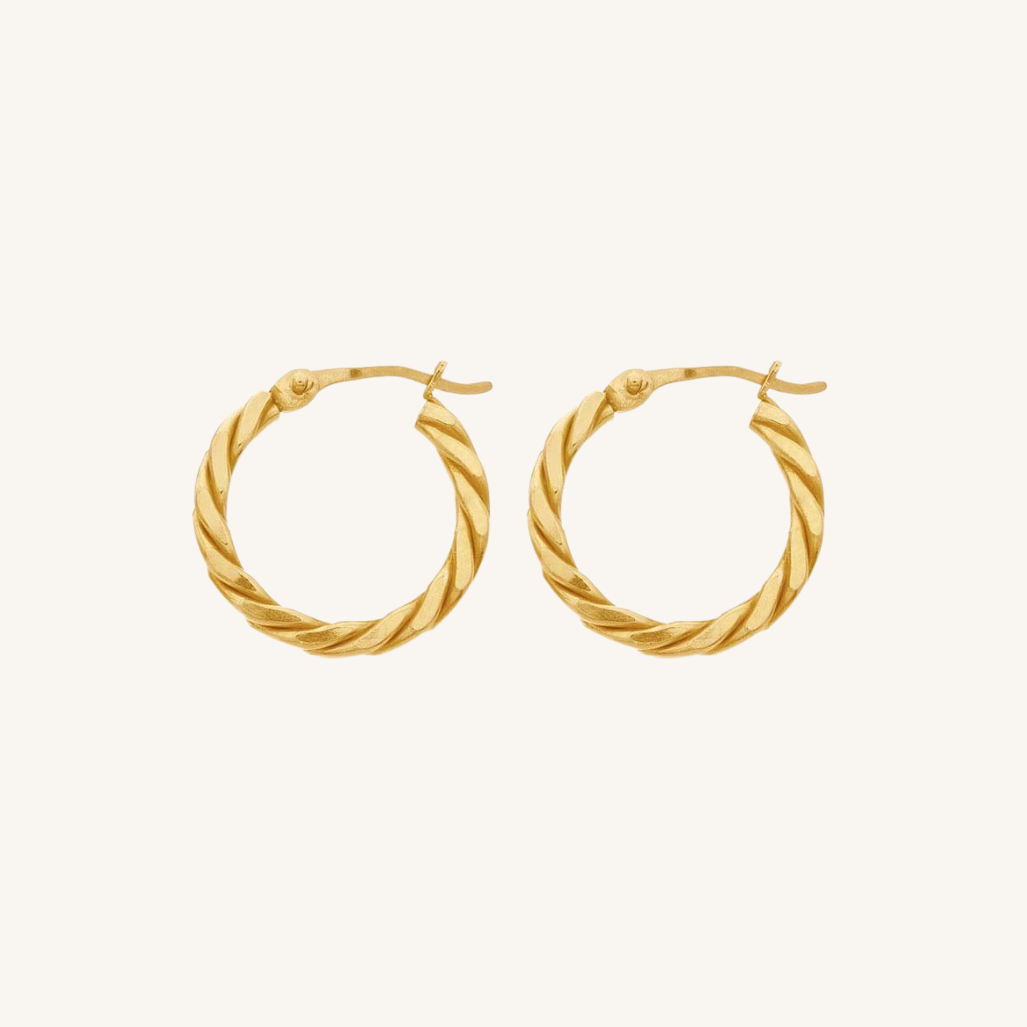 A pair of gold hoop earrings with a twisted rope texture, displayed on a clean, solid off-white background.