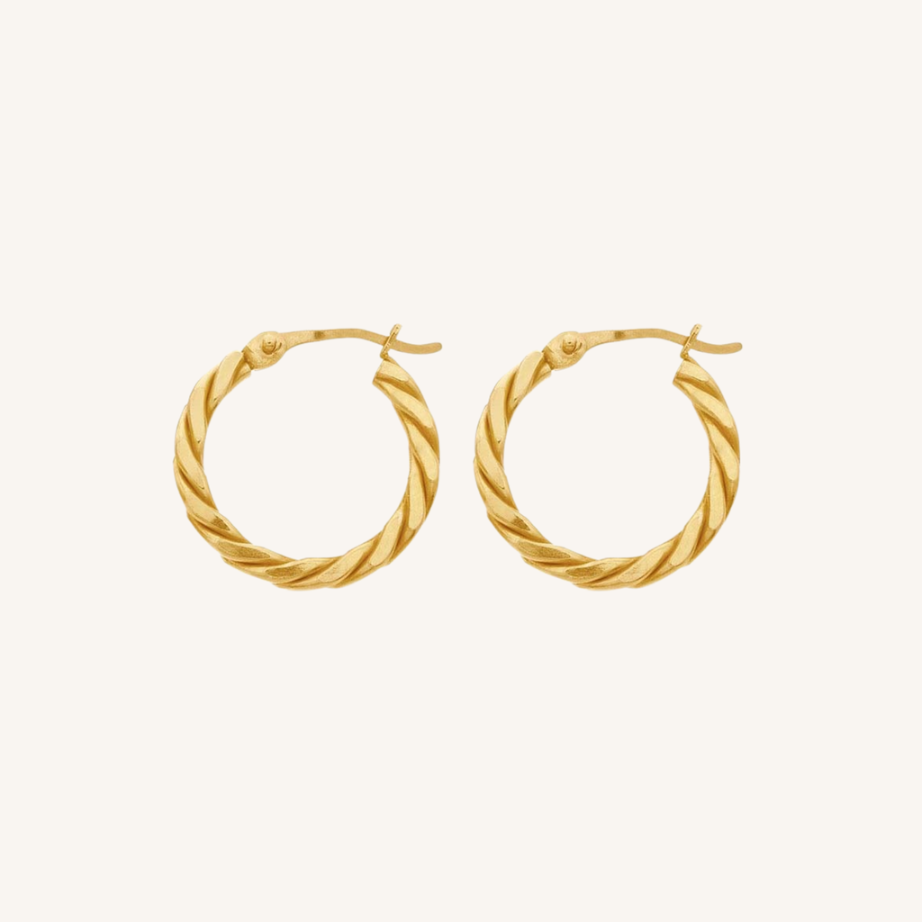 A pair of gold hoop earrings with a twisted rope texture, displayed on a clean, solid off-white background.