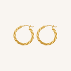 A pair of gold hoop earrings with a twisted rope texture, displayed on a clean, solid off-white background.