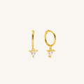 A pair of gold huggie hoop earrings with small triangular clear crystal charms, displayed on a clean off-white background.