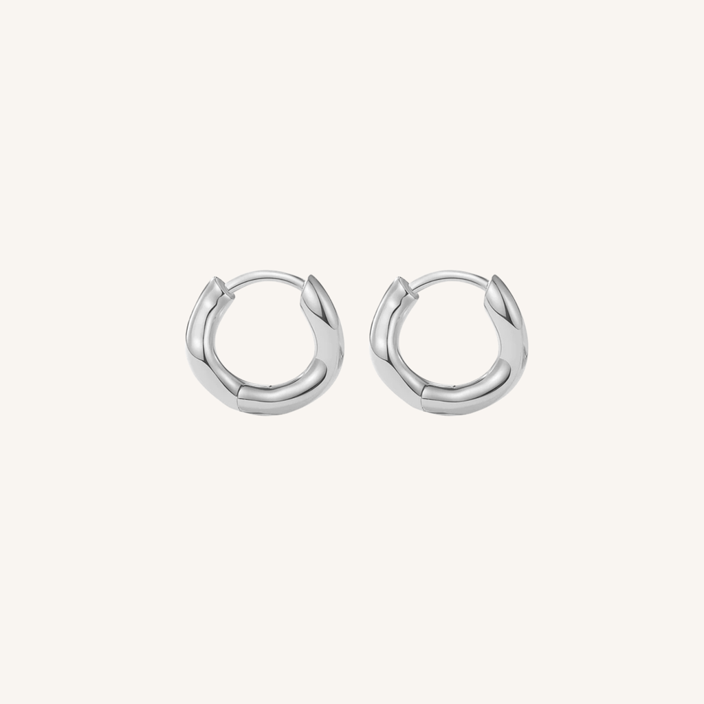 Pair of silver hoop earrings on a white background