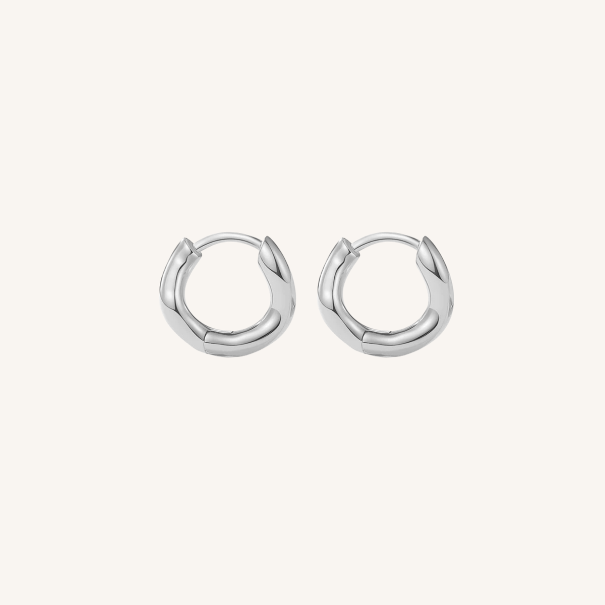 Pair of silver hoop earrings on a white background