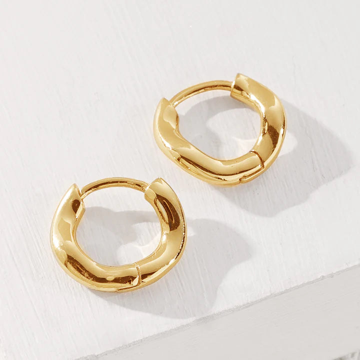 Close up of gold wave huggies in gold.